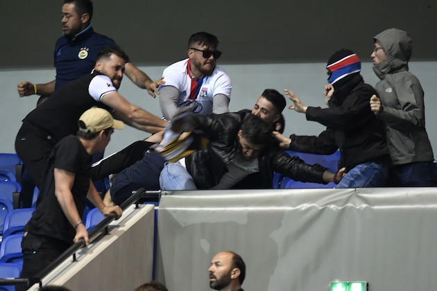 Besiktas' and Lyon's supporters fight before  the UEFA Europa League first leg quarter final football match between Lyon (OL) and Besiktas on April 13, 2017, at the Parc Olympique Lyonnais stadium in Decines-Charpieu, central-eastern France. / AFP PHOTO / PHILIPPE DESMAZES        (Photo credit should read PHILIPPE DESMAZES/AFP/Getty Images)
