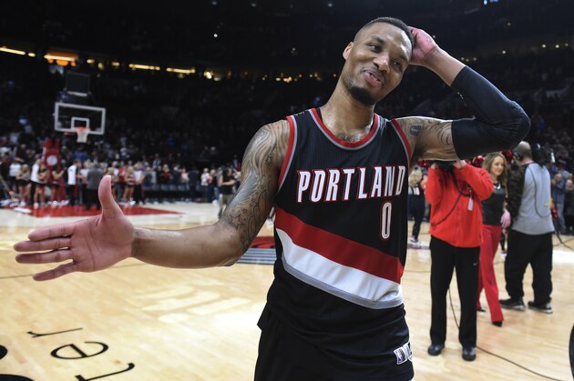 Portland Trail Blazers guard Damian Lillard smiles as he walks off the court after the team's NBA basketball game against the Utah Jazz in Portland, Ore., Saturday, April 8, 2017. Lillard scored 59 points as the Blazers won 101-86. (AP Photo/Steve Dykes)