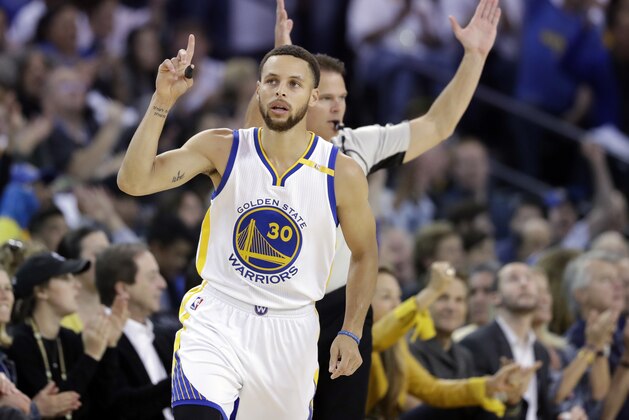 Golden State Warriors' Stephen Curry gestures after making a 3-point basket against the Los Angeles Lakers during the first half of an NBA basketball game, Wednesday, April 12, 2017, in Oakland, Calif. (AP Photo/Marcio Jose Sanchez)