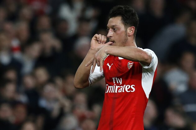 Arsenal's German midfielder Mesut Ozil celebrates after scoring the opening goal of the English Premier League football match between Arsenal and West Ham United at the Emirates Stadium in London on April 5, 2017.  / AFP PHOTO / Ian KINGTON / RESTRICTED TO EDITORIAL USE. No use with unauthorized audio, video, data, fixture lists, club/league logos or 'live' services. Online in-match use limited to 75 images, no video emulation. No use in betting, games or single club/league/player publications.  /         (Photo credit should read IAN KINGTON/AFP/Getty Images)