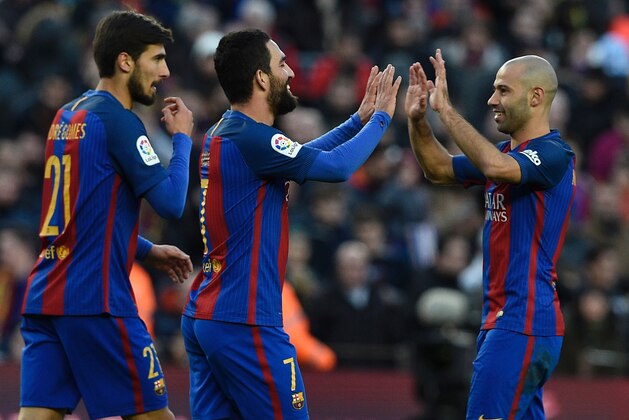 Barcelona's Turkish forward Arda Turan (L) celebrates with Barcelona's Argentinian defender Javier Mascherano (R) after scoring a goal during the Spanish league football match FC Barcelona vs UD Las Palmas at the Camp Nou stadium in Barcelona on January 14, 2017. / AFP / LLUIS GENE        (Photo credit should read LLUIS GENE/AFP/Getty Images)