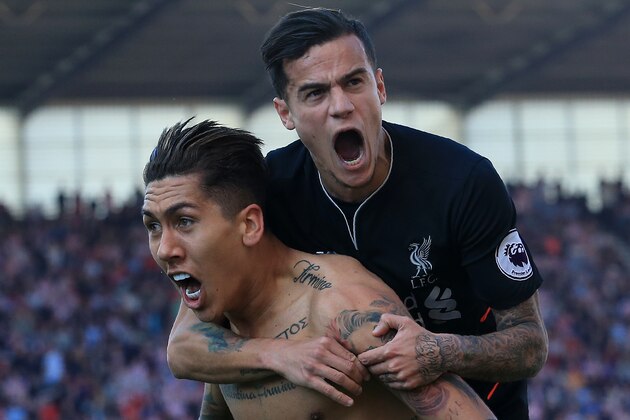 Liverpool's Brazilian midfielder Roberto Firmino (L) celebrates scoring his team's second goal with Liverpool's Brazilian midfielder Philippe Coutinho during the English Premier League football match between Stoke City and Liverpool at the Bet365 Stadium in Stoke-on-Trent, central England on April 8, 2017. / AFP PHOTO / Lindsey PARNABY / RESTRICTED TO EDITORIAL USE. No use with unauthorized audio, video, data, fixture lists, club/league logos or 'live' services. Online in-match use limited to 75 images, no video emulation. No use in betting, games or single club/league/player publications.  /         (Photo credit should read LINDSEY PARNABY/AFP/Getty Images)