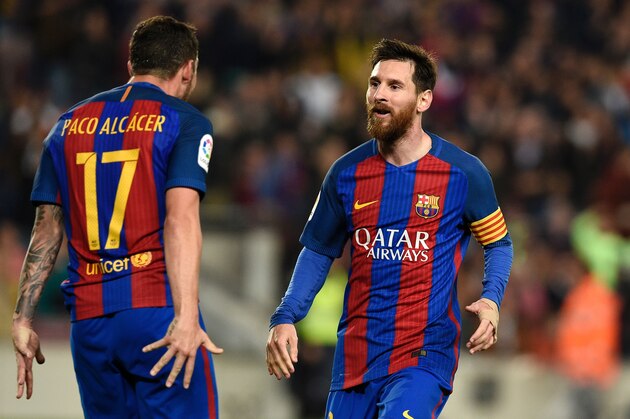 Barcelona's forward Paco Alcacer (L) celebrates a goal with Barcelona's Argentinian forward Lionel Messi during the Spanish league football match FC Barcelona vs Real Sociedad at the Camp Nou stadium in Barcelona on April 15, 2017. / AFP PHOTO / LLUIS GENE        (Photo credit should read LLUIS GENE/AFP/Getty Images)