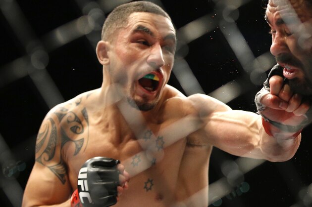 Robert Whittaker, left, hits Rafael Natal during a middleweight mixed martial arts bout at UFC 197, Saturday, April 23, 2016, in Las Vegas. (AP Photo/John Locher)