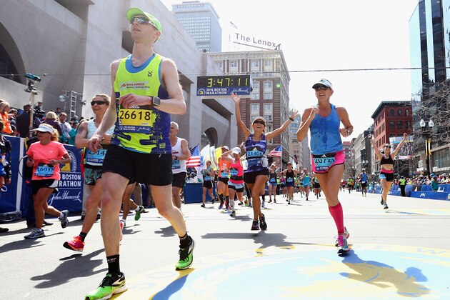 BOSTON, MA - APRIL 18:  Runners react after crossing the finish line to complete the 120th Boston Marathon on April 18, 2016 in Boston, Massachusetts.  (Photo by Maddie Meyer/Getty Images)