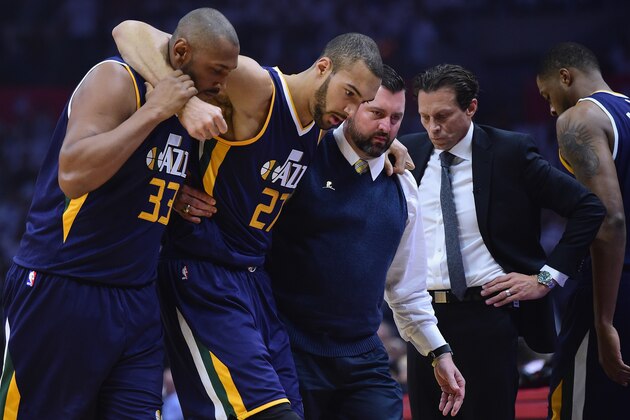 LOS ANGELES, CA - APRIL 15:  Rudy Gobert #27 of the Utah Jazz is helped off the court past head coach Quin Snyder, by Boris Diaw #33 and medical staff during the first half against the LA Clippers at Staples Center on April 15, 2017 in Los Angeles, California.  NOTE TO USER: User expressly acknowledges and agrees that, by downloading and or using this photograph, User is consenting to the terms and conditions of the Getty Images License Agreement.  (Photo by Harry How/Getty Images)
