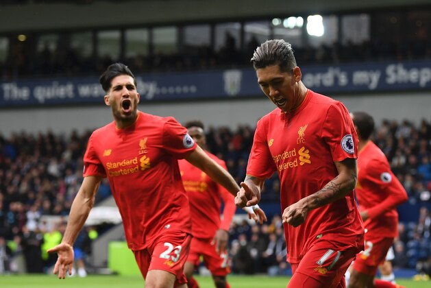 Liverpool's Brazilian midfielder Roberto Firmino (R) celebrates scoring the opening goal with Liverpool's German midfielder Emre Can during the English Premier League football match between West Bromwich Albion and Liverpool at The Hawthorns stadium in West Bromwich, central England, on April 16, 2017.
 / AFP PHOTO / Justin TALLIS / RESTRICTED TO EDITORIAL USE. No use with unauthorized audio, video, data, fixture lists, club/league logos or 'live' services. Online in-match use limited to 75 images, no video emulation. No use in betting, games or single club/league/player publications.  /         (Photo credit should read JUSTIN TALLIS/AFP/Getty Images)
