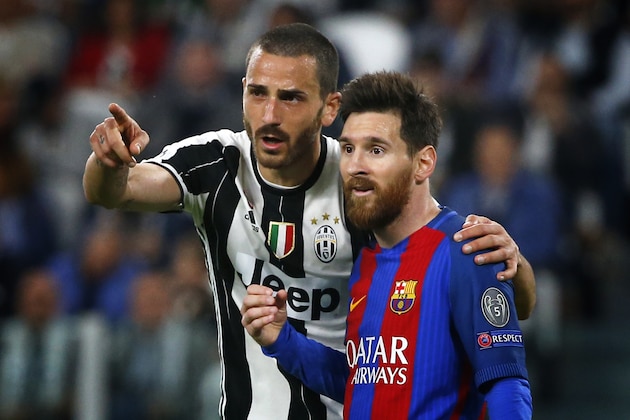 Juventus' defender Leonardo Bonucci (L) speaks to Barcelona's forward Lionel Messi from Argentina during the UEFA Champions League quarter final first leg football match Juventus vs Barcelona, on April 11, 2017 at the Juventus stadium in Turin.  / AFP PHOTO / Marco BERTORELLO        (Photo credit should read MARCO BERTORELLO/AFP/Getty Images)