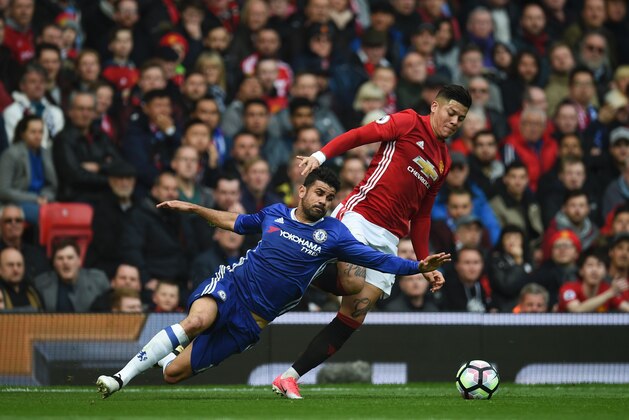 TOPSHOT - Chelsea's Brazilian-born Spanish striker Diego Costa (L) vies with Manchester United's Argentinian defender Marcos Rojo during the English Premier League football match between Manchester United and Chelsea at Old Trafford in Manchester, north west England, on April 16, 2017. / AFP PHOTO / Oli SCARFF / RESTRICTED TO EDITORIAL USE. No use with unauthorized audio, video, data, fixture lists, club/league logos or 'live' services. Online in-match use limited to 75 images, no video emulation. No use in betting, games or single club/league/player publications.  /         (Photo credit should read OLI SCARFF/AFP/Getty Images)