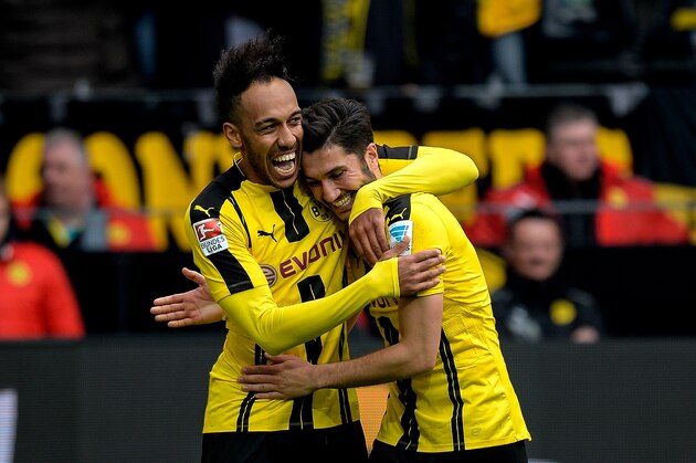 Dortmund's Gabonese forward Pierre-Emerick Aubameyang (L) celebrates his 3-1 goal during the German First division Bundesliga football match between Borussia Dortmund and Eintracht Frankfurt in Dortmund, western Germany, on April 15, 2017. / AFP PHOTO / SASCHA SCHUERMANN / RESTRICTIONS: DURING MATCH TIME: DFL RULES TO LIMIT THE ONLINE USAGE TO 15 PICTURES PER MATCH AND FORBID IMAGE SEQUENCES TO SIMULATE VIDEO. == RESTRICTED TO EDITORIAL USE == FOR FURTHER QUERIES PLEASE CONTACT DFL DIRECTLY AT + 49 69 650050
        (Photo credit should read SASCHA SCHUERMANN/AFP/Getty Images)