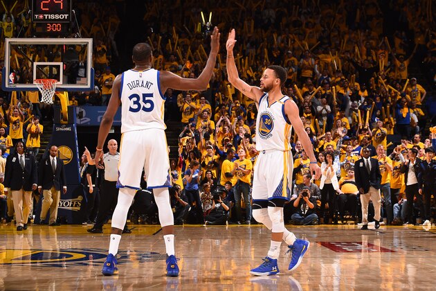 OAKLAND, CA - APRIL 16: Kevin Durant #35 and Stephen Curry #30 of the Golden State Warriors high five during the game against the Portland Trail Blazers during the Western Conference Quarterfinals of the 2017 NBA Playoffs on April 16, 2017 at ORACLE Arena in Oakland, California. NOTE TO USER: User expressly acknowledges and agrees that, by downloading and or using this photograph, user is consenting to the terms and conditions of Getty Images License Agreement. Mandatory Copyright Notice: Copyright 2017 NBAE (Photo by Noah Graham/NBAE via Getty Images)