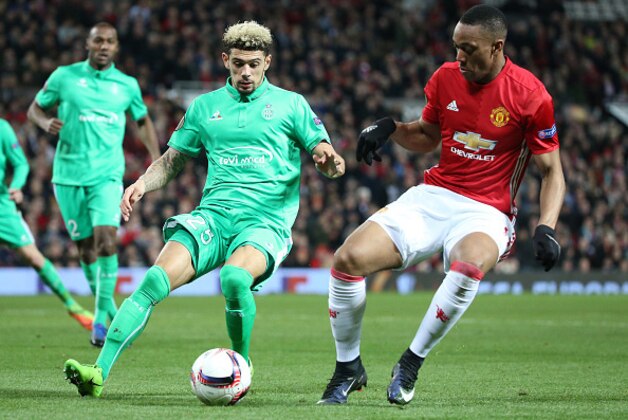 MANCHESTER, ENGLAND - FEBRUARY 16: Kevin Malcuit of Saint-Etienne and Anthony Martial of Manchester United in action during the UEFA Europa League Round of 32 first leg match between Manchester United and AS Saint-Etienne (ASSE) at Old Trafford stadium on February 16, 2017 in Manchester, United Kingdom. (Photo by Jean Catuffe/Getty Images)