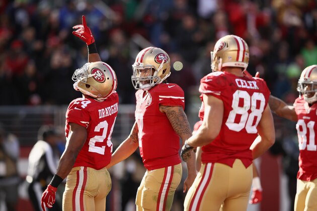 SANTA CLARA, CA - JANUARY 01:  Shaun Draughn #24 of the San Francisco 49ers is congratulated by Colin Kaepernick #7 of the San Francisco 49ers after he ran in for a touchdown against the Seattle Seahawks at Levi's Stadium on January 1, 2017 in Santa Clara, California.  (Photo by Ezra Shaw/Getty Images)