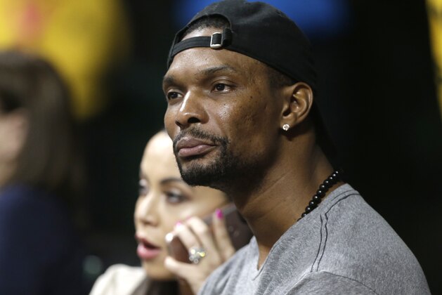 Miami Heat forward Chris Bosh and his wife, Adrienne, attend an NCAA college basketball game between Miami and Georgia Tech, Wednesday, Feb. 15, 2017, in Coral Gables, Fla. (AP Photo/Lynne Sladky)