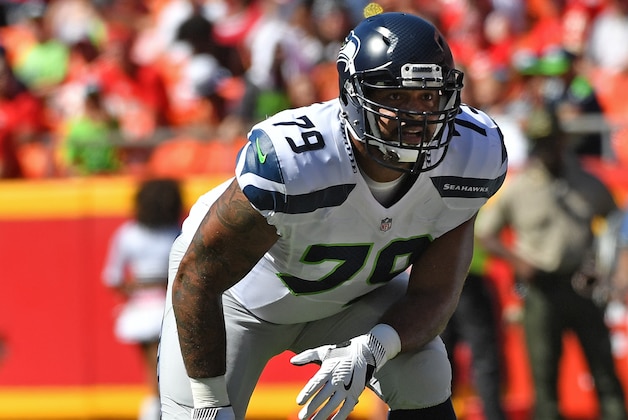 KANSAS CITY, MO - AUGUST 13:  Offensive tackle Garry Gilliam #79 of the Seattle Seahawks gets set on the line against the Kansas City Chiefs during the first half on August 13, 2016 at Arrowhead Stadium in Kansas City, Missouri.  (Photo by Peter G. Aiken/Getty Images)