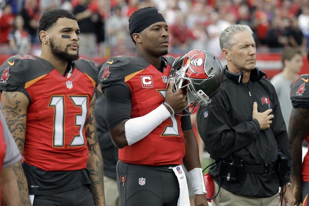 Tampa Bay Buccaneers wide receiver Mike Evans (13), quarterback Jameis Winston (3) and head coach Dirk Koetter during the National Anthem before an NFL football game against the New Orleans Saints Sunday, Dec. 11, 2016, in Tampa, Fla. (AP Photo/Chris O'Meara)