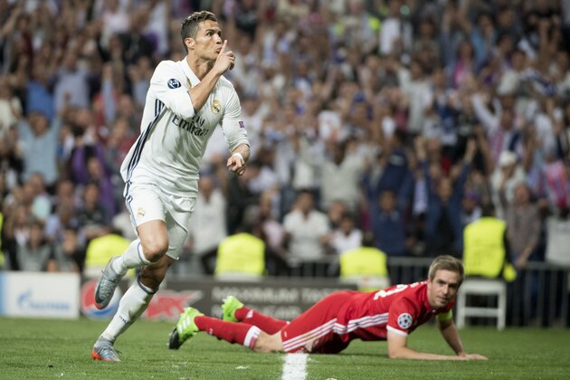Real Madrid's Portuguese forward Cristiano Ronaldo celebrates scoring during the UEFA Champions League quarter-final second leg football match Real Madrid vs FC Bayern Munich at the Santiago Bernabeu stadium in Madrid in Madrid on April 18, 2017. / AFP PHOTO / CURTO DE LA TORRE        (Photo credit should read CURTO DE LA TORRE/AFP/Getty Images)