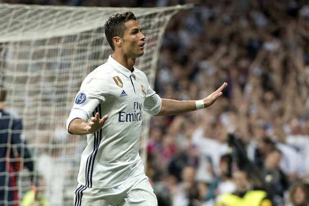 Real Madrid's Portuguese forward Cristiano Ronaldo celebrates scoring during the UEFA Champions League quarter-final second leg football match Real Madrid vs FC Bayern Munich at the Santiago Bernabeu stadium in Madrid in Madrid on April 18, 2017. / AFP PHOTO / CURTO DE LA TORRE        (Photo credit should read CURTO DE LA TORRE/AFP/Getty Images)
