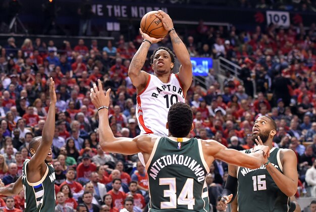 Apr 18, 2017; Toronto, Ontario, CAN;  Toronto Raptors guard DeMar DeRozan (10) shoots for a basket over  Milwaukee Bucks forward Giannis Antetokounmpo (34) in the second half of  game two of the first round of the 2017 NBA Playoffs at Air Canada Centre. Mandatory Credit: Dan Hamilton-USA TODAY Sports