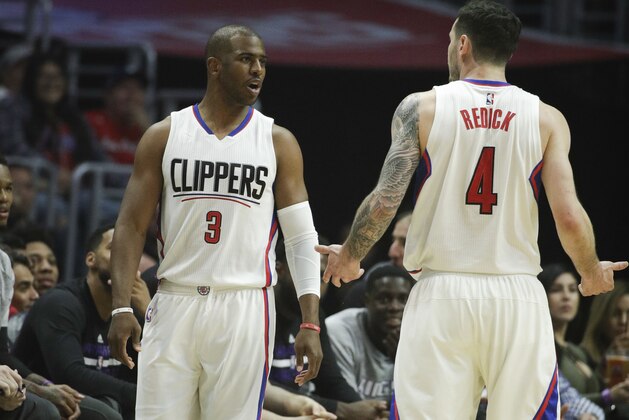 Los Angeles Clippers' JJ Redick talks to Chris Paul during the first half of an NBA basketball game against the Sacramento Kings Wednesday, April 12, 2017, in Los Angeles. (AP Photo/Jae C. Hong)