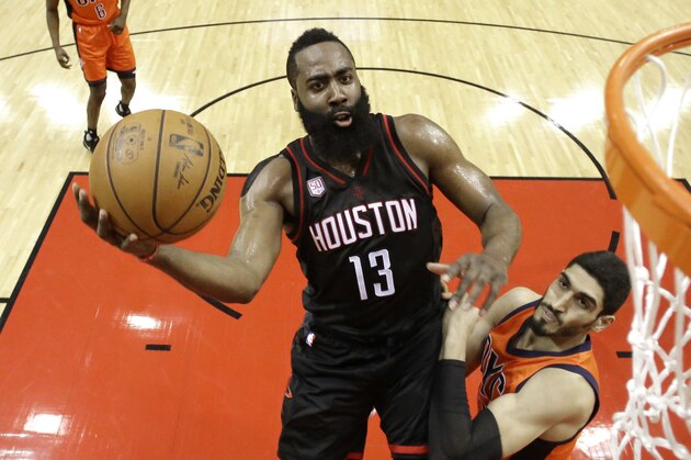 Houston Rockets' James Harden (13) goes up for a shot as Oklahoma City Thunder's Enes Kanter defends during the first half in Game 1 of an NBA basketball first-round playoff series, Sunday, April 16, 2017, in Houston. (AP Photo/David J. Phillip)