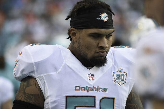 MIAMI GARDENS, FL - SEPTEMBER 27:  Mike Pouncey #51 of the Miami Dolphins looks on during a NFL game against the Buffalo Bills at Sun Life Stadium on September 27, 2015 in Miami Gardens, Florida.  (Photo by Ron Elkman/Sports Imagery/Getty Images)