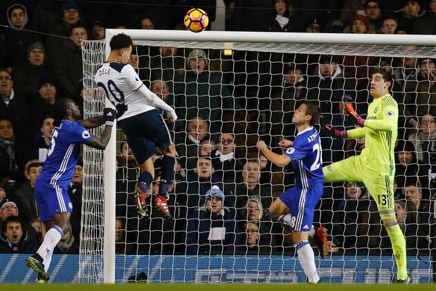 Tottenham Hotspur's English midfielder Dele Alli (2nd L) jumps to score his and Totenham's second goal with this header during the English Premier League football match between Tottenham Hotspur and Chelsea at White Hart Lane in London, on January 4, 2017. / AFP / Adrian DENNIS / RESTRICTED TO EDITORIAL USE. No use with unauthorized audio, video, data, fixture lists, club/league logos or 'live' services. Online in-match use limited to 75 images, no video emulation. No use in betting, games or single club/league/player publications.  /         (Photo credit should read ADRIAN DENNIS/AFP/Getty Images)