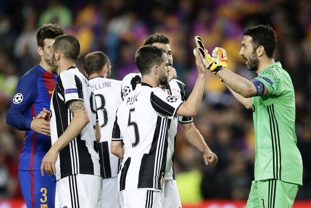 Juventus goalkeeper Gianluigi Buffon, right, celebrates with teammates after the Champions League quarterfinal second leg soccer match between Barcelona and Juventus at Camp Nou stadium in Barcelona, Spain, Wednesday, April 19, 2017. (AP Photo/Manu Fernandez)