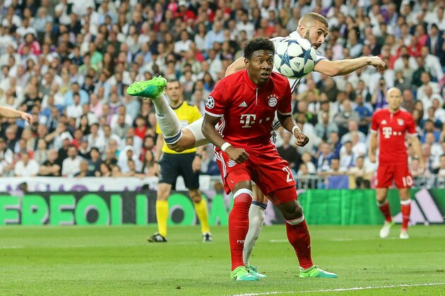 MADRID, SPAIN - APRIL 18: Karim Benzema of Real Madrid and David Alaba of Bayern Muenchen battle for the ball during the UEFA Champions League Quarter Final second leg match between Real Madrid CF and FC Bayern Muenchen at Estadio Santiago Bernabeu on April 18, 2017 in Madrid, Spain. (Photo by TF-Images/Getty Images)