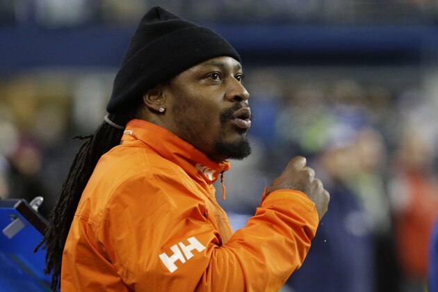 Former Seattle Seahawks running back Marshawn Lynch stands on the sidelines and chats with players on the bench in the second half of an NFL football game against the Carolina Panthers, Sunday, Dec. 4, 2016, in Seattle. (AP Photo/Ted S. Warren)