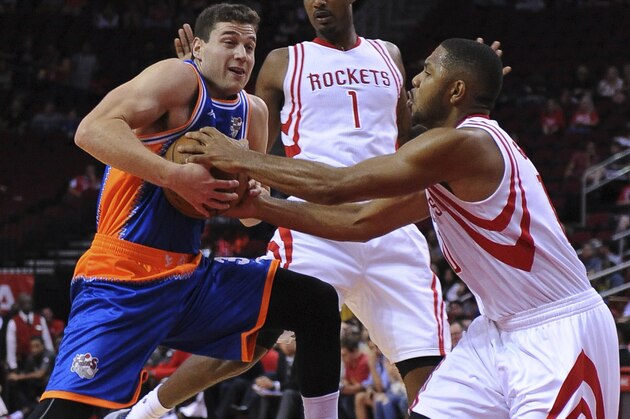 The Shanghai Sharks Jimmer Fredette, left, is defended by the Houston Rockets Eric Gordon (10)  in the first half of an NBA basketball exhibition game Sunday, Oct. 2, 2016, in Houston. (AP Photo/George Bridges)