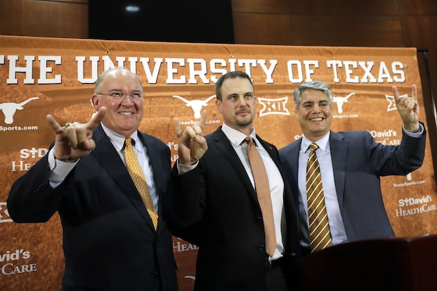 Tom Herman, center, poses with athletic director Mike Perrin, left, and school president Gregory Fenves, right, during a news conference where he was introduced at Texas' new head NCAA college football coach, Sunday, Nov. 27, 2016, in Austin. (AP Photo/Eric Gay)