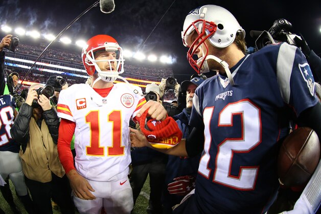 FOXBORO, MA - JANUARY 16:  Alex Smith #11 of the Kansas City Chiefs and Tom Brady #12 of the New England Patriots speak after the AFC Divisional Playoff Game at Gillette Stadium on January 16, 2016 in Foxboro, Massachusetts. The Patriots defeated the Chiefs 27-20.  (Photo by Maddie Meyer/Getty Images)