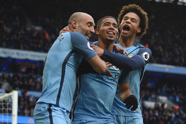 Manchester City's Brazilian striker Gabriel Jesus (C) celebrates with Manchester City's Argentinian defender Pablo Zabaleta (L) and Manchester City's German midfielder Leroy Sane (R) after scoring their late winning goal during the English Premier League football match between Manchester City and Swansea City at the Etihad Stadium in Manchester, north west England, on February 5, 2017.
Manchester City won the game 2-1. / AFP / PAUL ELLIS / RESTRICTED TO EDITORIAL USE. No use with unauthorized audio, video, data, fixture lists, club/league logos or 'live' services. Online in-match use limited to 75 images, no video emulation. No use in betting, games or single club/league/player publications.  /         (Photo credit should read PAUL ELLIS/AFP/Getty Images)