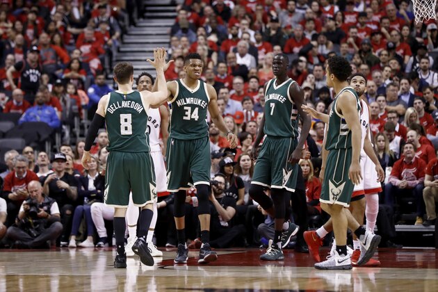 TORONTO, CANADA - APRIL 18:  Giannis Antetokounmpo #34 and Matthew Dellavedova #8 of the Milwaukee Bucks high-five during the game against the Toronto Raptors during Game Two of the Eastern Conference Quarterfinals of the 2017 NBA Playoffs on April 18, 2017 at the Air Canada Centre in Toronto, Ontario, Canada.  NOTE TO USER: User expressly acknowledges and agrees that, by downloading and or using this Photograph, user is consenting to the terms and conditions of the Getty Images License Agreement.  Mandatory Copyright Notice: Copyright 2017 NBAE (Photo by Mark Blinch/NBAE via Getty Images)