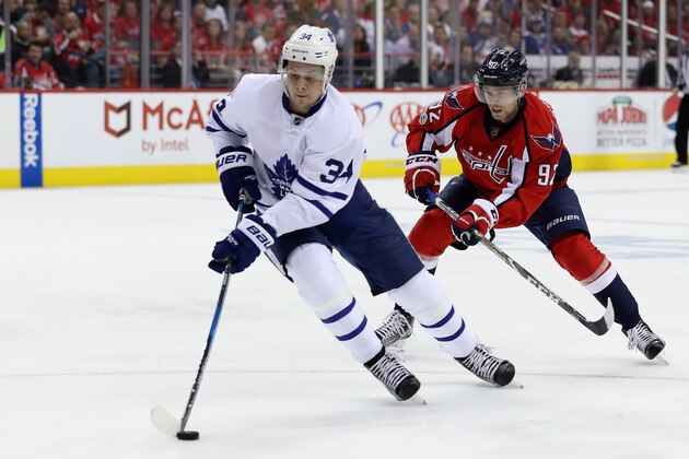 WASHINGTON, DC - APRIL 21: Auston Matthews #34 of the Toronto Maple Leafs moves the puck in front of Evgeny Kuznetsov #92 of the Washington Capitals   in Game Five of the Eastern Conference First Round during the 2017 NHL Stanley Cup Playoffs at Verizon Center on April 21, 2017 in Washington, DC.  (Photo by Rob Carr/Getty Images)