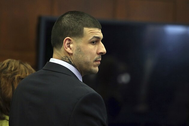 Former New England Patriots tight end Aaron Hernandez stands at the defense table when court is adjourned without a verdict on day five of jury deliberations in his double murder trial at Suffolk Superior Court on Thursday, April 13, 2017. Hernandez is standing trial for the July 2012 killings of Daniel de Abreu and Safiro Furtado who he encountered in a Boston nightclub. The former NFL player is already serving a life sentence in the 2013 killing of semi-professional football player Odin Lloyd. (Nancy Lane/The Boston Herald via AP, Pool)