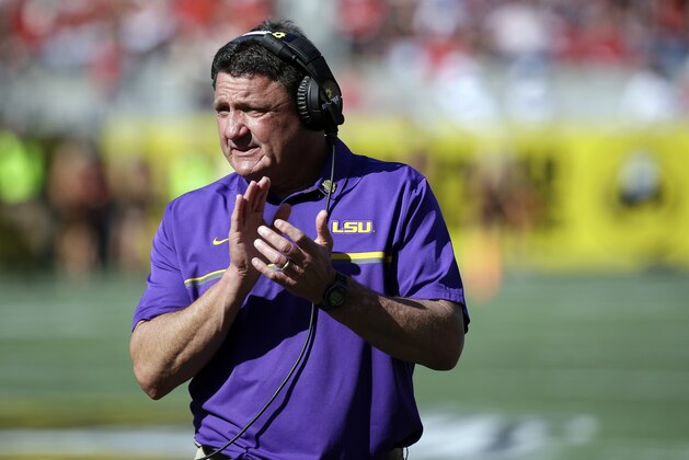 LSU head coach Ed Orgeron encourages players during the second half of the Citrus Bowl NCAA football game against Louisville, Saturday, Dec. 31, 2016, in Orlando, Fla. LSU won 29-9. (AP Photo/John Raoux)