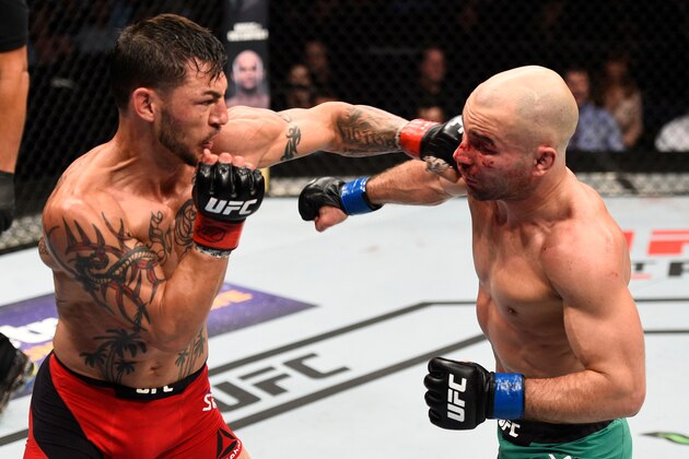 NASHVILLE, TN - APRIL 22:  (L-R) Cub Swanson punches Artem Lobov of Russia in their featherweight bout during the UFC Fight Night event at Bridgestone Arena on April 22, 2017 in Nashville, Tennessee. (Photo by Jeff Bottari/Zuffa LLC/Zuffa LLC via Getty Images)
