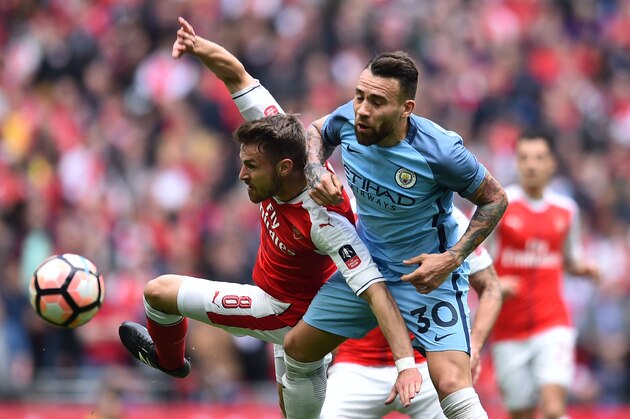 Arsenal's Welsh midfielder Aaron Ramsey (L) vies with Manchester City's Argentinian defender Nicolas Otamendi during the FA Cup semi-final football match between Arsenal and Manchester City at Wembley stadium in London on April 23, 2017. / AFP PHOTO / Glyn KIRK / NOT FOR MARKETING OR ADVERTISING USE / RESTRICTED TO EDITORIAL USE
        (Photo credit should read GLYN KIRK/AFP/Getty Images)