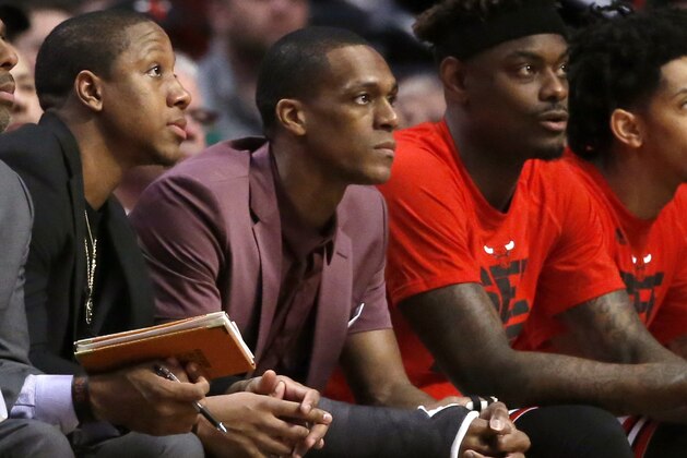 With a cast on his right thumb, Chicago Bulls' Rajon Rondo, center, sits on the bench during Game 3 of the team's NBA basketball first-round playoff series against the Boston Celtics in Chicago, Friday, April 21, 2017. (AP Photo/Charles Rex Arbogast)