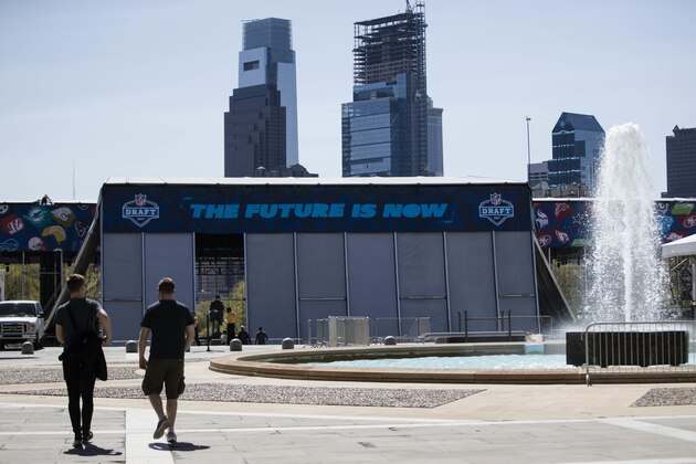 People walk from the Philadelphia Museum of Art as construction continues on the museum's steps for the upcoming 2017 NFL football draft in Philadelphia, Tuesday, April 18, 2017. (AP Photo/Matt Rourke)