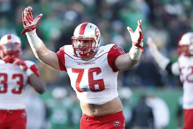 HUNTINGTON, WV - NOVEMBER 28: Forrest Lamp #76 of the Western Kentucky Hilltoppers celebrates after a touchdown against the Marshall Thundering Herd during the game at Joan C. Edwards Stadium on November 28, 2014 in Huntington, West Virginia. Western Kentucky defeated Marshall 67-66 in overtime. (Photo by Joe Robbins/Getty Images)