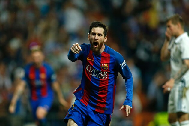 Barcelona's Argentinian forward Lionel Messi celebrates after scoring during the Spanish league Clasico football match Real Madrid CF vs FC Barcelona at the Santiago Bernabeu stadium in Madrid on April 23, 2017. / AFP PHOTO / OSCAR DEL POZO        (Photo credit should read OSCAR DEL POZO/AFP/Getty Images)