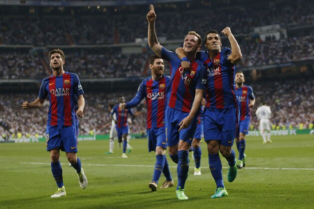 Barcelona's Ivan Rakitic, 3rd left celebrates with Luis Suarez after scoring during a Spanish La Liga soccer match between Real Madrid and Barcelona, dubbed 'el clasico', at the Santiago Bernabeu stadium in Madrid, Spain, Sunday, April 23, 2017. (AP Photo/Daniel Ochoa de Olza)