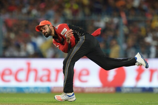 Royal Challengers Bangalore captain Virat Kohli fields the ball during the 2016 Indian Premier League (IPL) Twenty20 cricket match between Kolkata Knight Riders and Royal Challengers Bangalore at the Eden Gardens Cricket Stadium in Kolkata on May 16, 2016.  ----IMAGE RESTRICTED TO EDITORIAL USE - STRICTLY NO COMMERCIAL USE----- / GETTYOUT' / AFP / Dibyangshu SARKAR        (Photo credit should read DIBYANGSHU SARKAR/AFP/Getty Images)