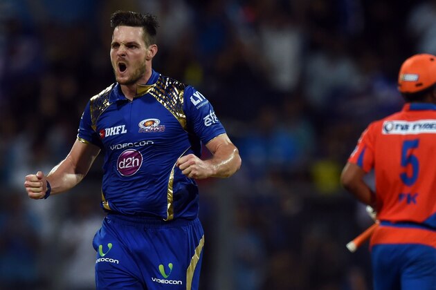 Mumbai Indians Mitchell McClenaghan (L) celebrates after taking the wicket of Gujarat Lions Praveen Kumar during the 2016 Indian Premier League(IPL) Twenty20 cricket match between Gujarat Lions and Mumbai Indians at the Wankhede Stadium in Mumbai on April 16, 2016.  / AFP / INDRANIL MUKHERJEE / ----IMAGE RESTRICTED TO EDITORIAL USE - STRICTLY NO COMMERCIAL USE----- / GETTYOUT        (Photo credit should read INDRANIL MUKHERJEE/AFP/Getty Images)