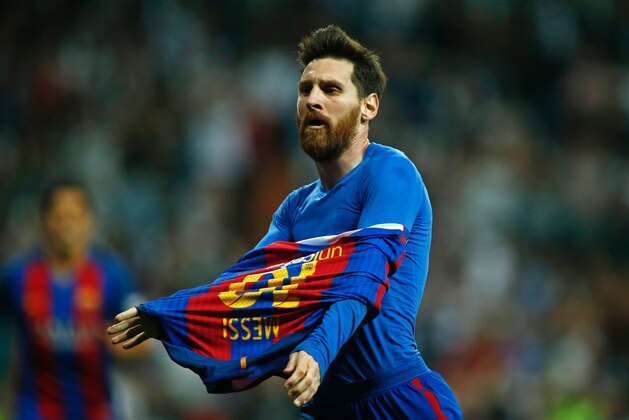Barcelona's Argentinian forward Lionel Messi celebrates after scoring during the Spanish league Clasico football match Real Madrid CF vs FC Barcelona at the Santiago Bernabeu stadium in Madrid on April 23, 2017. / AFP PHOTO / OSCAR DEL POZO        (Photo credit should read OSCAR DEL POZO/AFP/Getty Images)