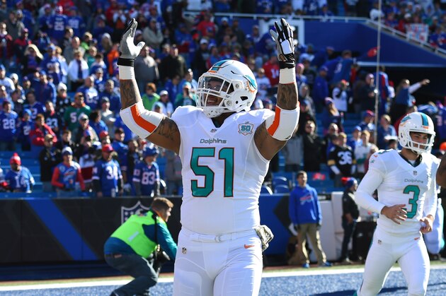 SYRACUSE, NY - NOVEMBER 08:  Mike Pouncey #51 of the Miami Dolphins gestures to the crowd prior to the game against the Buffalo Bills at Ralph Wilson Stadium on November 8, 2015 in Orchard Park, New York.  Buffalo defeated Miami 33-17.  (Photo by Rich Barnes/Getty Images)