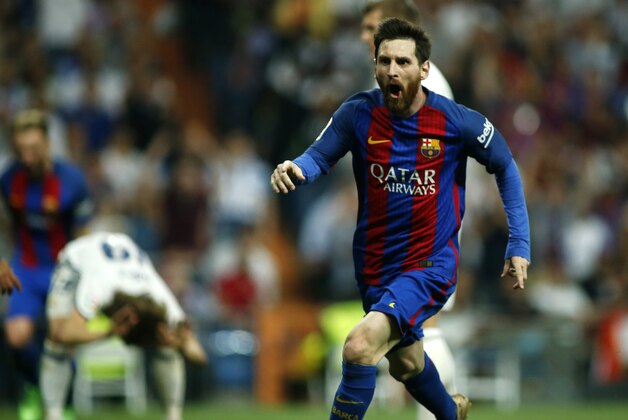 Barcelona's Argentinian forward Lionel Messi celebrates Barcelona's third goal during the Spanish league football match Real Madrid CF vs FC Barcelona at the Santiago Bernabeu stadium in Madrid on April 23, 2017. / AFP PHOTO / OSCAR DEL POZO        (Photo credit should read OSCAR DEL POZO/AFP/Getty Images)